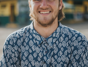 Smiling young man with a beard wearing a shirt